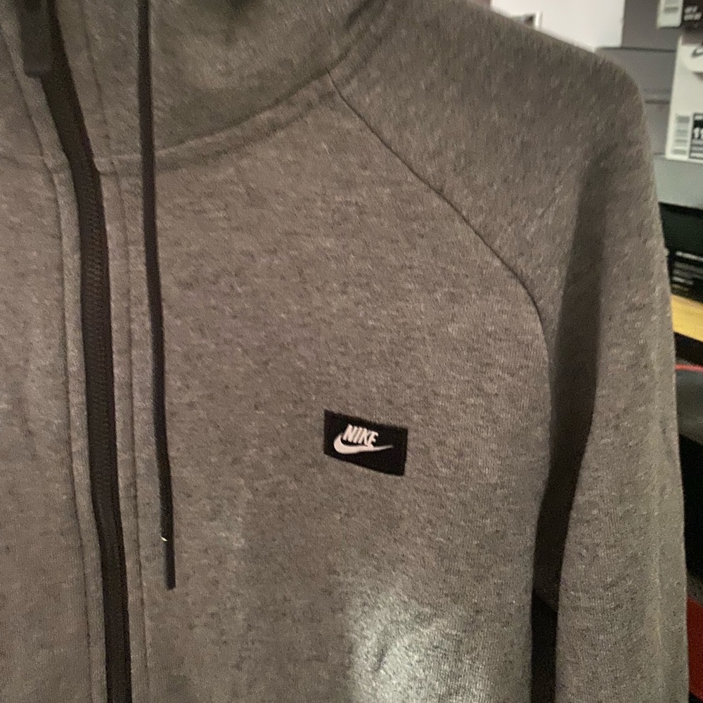 Grey Nike zip up hoodie.
